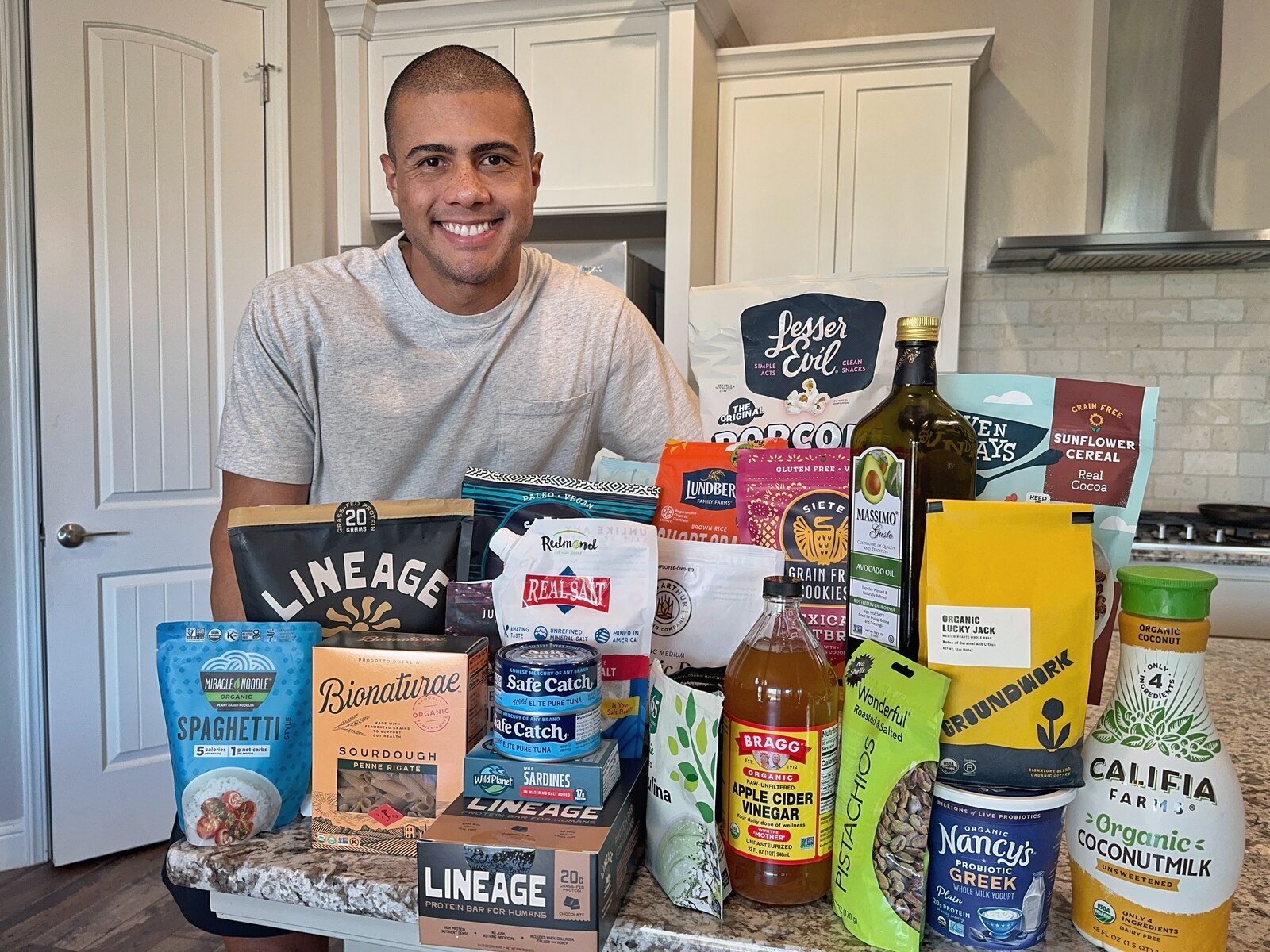 César Ramos in his kitchen with 300+ clean grocery products he's personally tested.