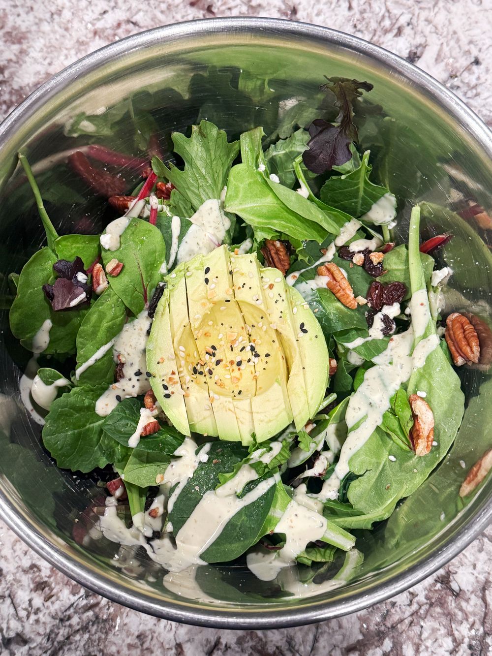 An aesthetic salad bowl with clean grocery essentials.