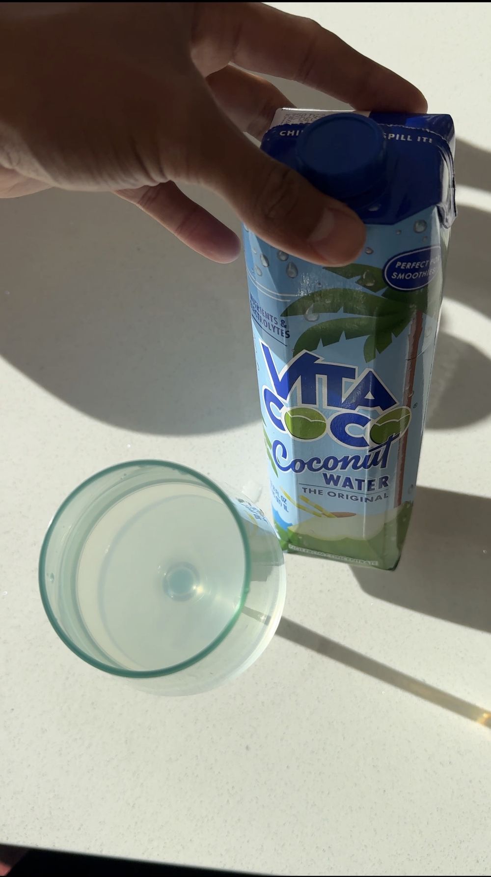 Coconut water in a glass — natural hydration as a wellness essential.