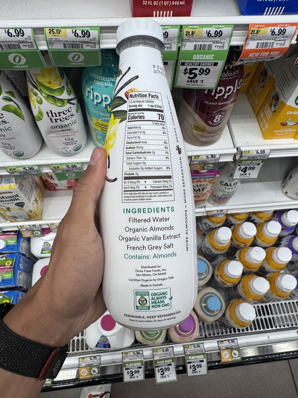 Checking the ingredient list on a packaged grocery product.