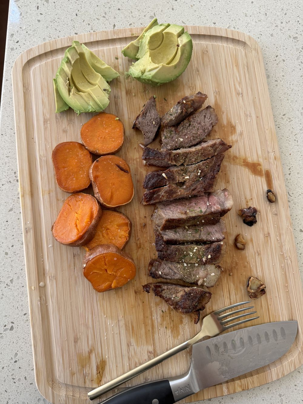 Real food board with grass-fed meat, avocado, and clean ingredients.